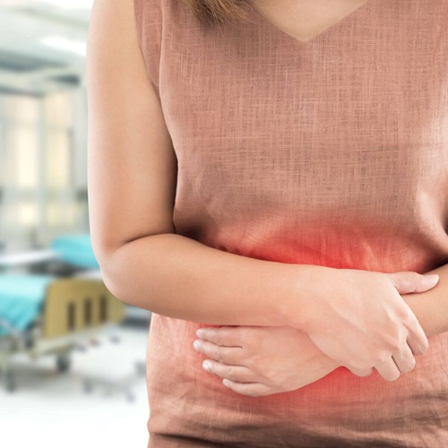woman with stomach cramps in a traveller's clinic
