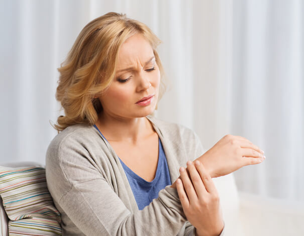 Woman holding her wrist because of pain