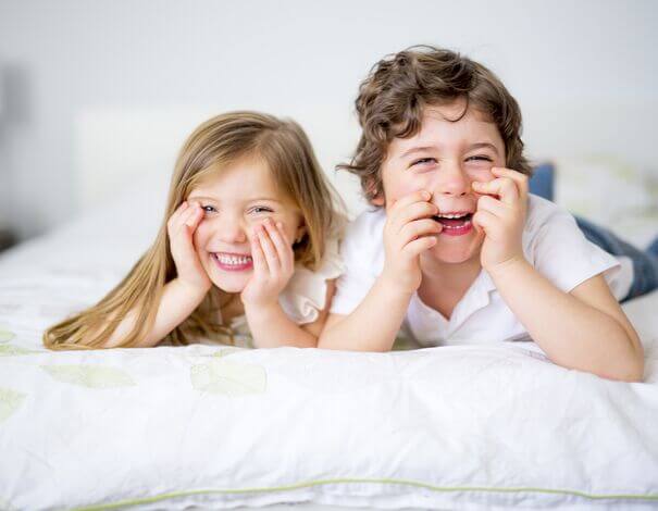 Girl child and boy child making funny faces