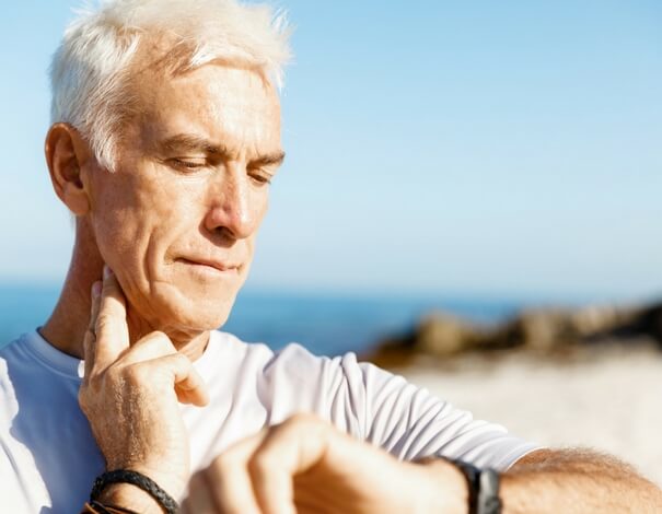 senior taking his pulse senior taking his pulse